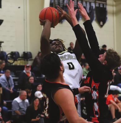 Archer City’s Elijah Jackson shoots over a pair of Petrolia defenders in the first half of the Wildcats’ 44-43 overtime loss to the Pirates on Tuesday, Feb. 1. Photo/Will Edwards