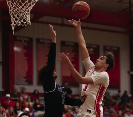 Eagle guard Ty Harrison floats a shot over a Mustangdefender in Holliday’s home win versus City View on Friday, Feb. 13. Photo/Landon Davis