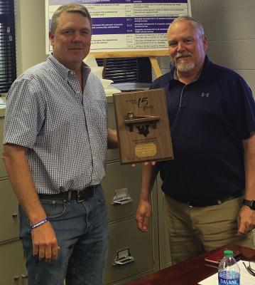 Outgoing Windthorst ISD board president Chad Steinberger was presented with a plaque for his 15 years of service to the board by interim superintdent Ted West. Courtesy photo/Heather Crain