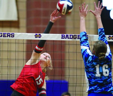 Lady Eagle Outside Hitter Claire Steinruck hammers down a kill against the Odessa Compass Academy Lady Cougars during the Holliday win on Tuesday, Nov. 12, in Merkel. Photo/Jerry Phillips