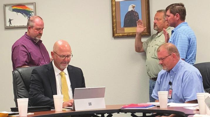 Business Administrator Dustin Scobee swears in board members Phillip Dowd and Eric Morris at the Holliday ISD school board meeting Tuesday, May 17. Photo/Nathan Lawson