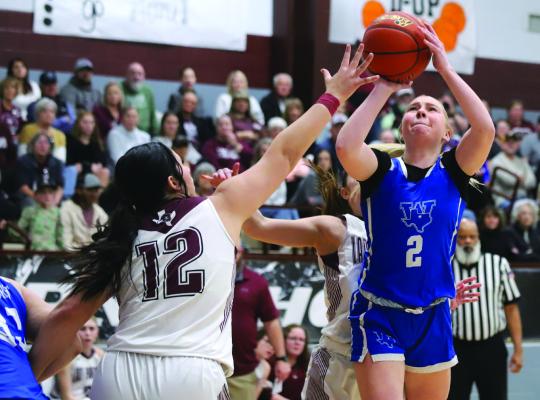 Trojanette guard Megg Lindley attempts a shot over a Lady Panther defender in Windthorst’s district matchup with Seymour on Tuesday, Jan. 28. Photo/Landon Davis