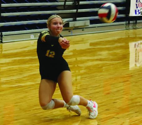 Lady Cat Libero Ashlyn Harvey slides over for a save in Archer City’s matchup with Levelland during the Graham tournament. Photo/Landon Davis