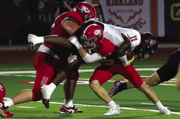 A pair of Holliday defenders make a stop on a Burkburnett Bulldog during last weeks game. The Eagles fell to Jim Ned 17-15 in Jim Ned on Friday, Sept. 27. Photo Landon Davis