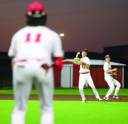 Holliday shortstop Kelson Wales makes the throw to first baseman Jackson Bishop in the Eagles’ district clash with Henrietta on Friday, March 20. Photo/Landon Davis