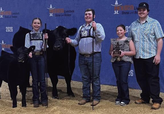 Brantley Humpert with his 1st place Angus class in Houston .