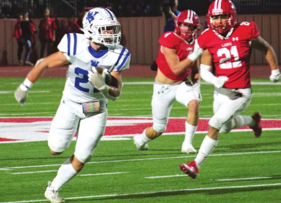 Windthorst’s Clay Hoff turns the corner on the Albany defense in the Trojans’ 28-14 regional final loss to the Lions on Friday, Dec. 3, in Graham. Photo/Nathan Lawson
