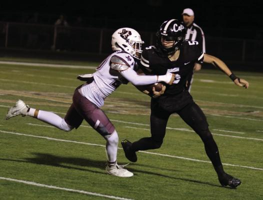 Archer City Quarterback Landon Smith avoids a tackle in the Wildcats 38-30 overtime victory over Seymour on Friday, Nov. 8. Photo/Jerry Phillips