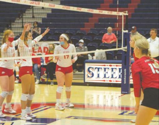 Holliday's Brittany James, Addison Lindemann and Campbell Juracek get set up for the next point during the bi-district match against Eastland in Graham Thursday, Oct. 29. Photo/Nathan Lawson