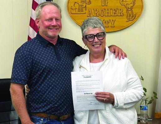 Archer City Mayor Steven Schroeder and City Secretary Kim Whitsitt pose for a photo following Schroeder's proclaimation of April 25 as Kim Whitsitt Day. Photo/Nathan Lawson