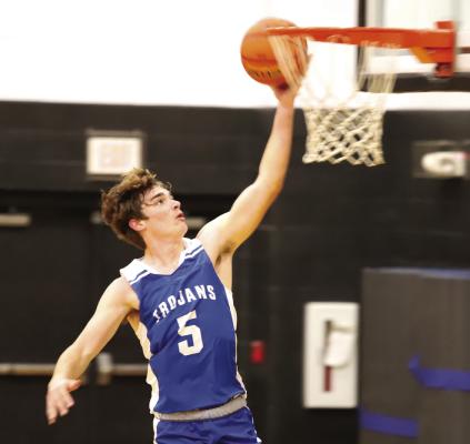 Windthorst's Brayden Berend goes up for layup against Henrietta in the Trojans 6961 loss on Thursday, Dec. 21. Photo/Landon Davis