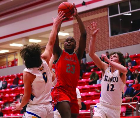 Senior Eric Bristow fights through two Blanco defenders in Holliday’s Area playoff matchup versus the Panthers on Friday, Feb. 21 in Glen Rose. Photo/Landon Davis