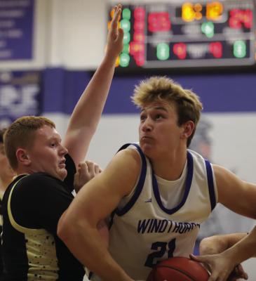 Windthorst post Jaxon Stark eyes the hoop while Archer City’s Noah Reneau defends him in the Trojans’ home win over the Wildcats on Tuesday, Jan. 13. Stark finished the game with a season high 32 points. Photo/Landon Davis