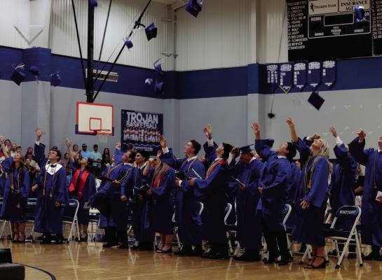 Windthorst graduates toss their caps into the air following the conclusion of the ceremony on Sunday. Photo/Landon Davis
