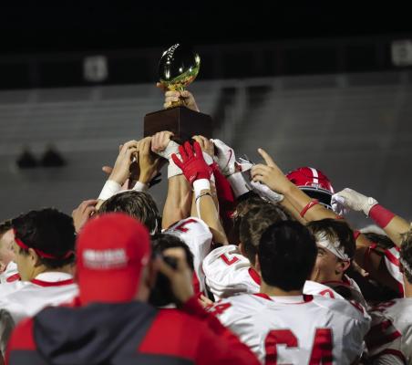 Holliday celebrates the district title with the gold ball trophy following the Eagles 36-14 win over Jacksboro on Friday, Nov. 8. Photo/Landon Davis