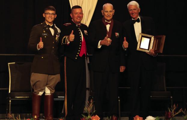 On stage are L-R: Corps Commander John Andruss, Corps Commandant LtGen James Bierman, Mr. James A. 'Jack' Carey, CCA President &amp; CEO Dr. Bruce Hamilton, and a member of the Ross Volunteer Company. Courtesy photo/AR Photography
