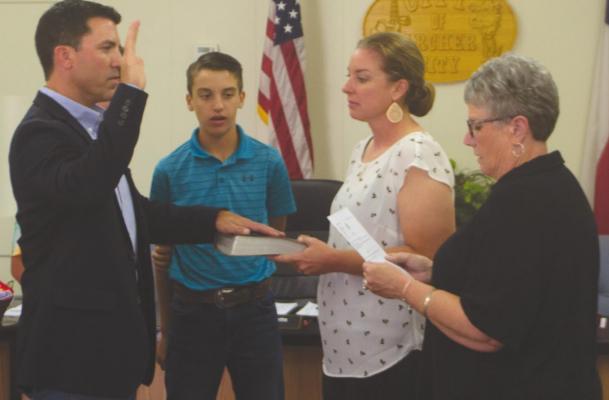 New Mayor Jake Truette (left) is sworn into office by City Secretary Kim Whitsitt with his family by his side at the council meeting Thursday, May 17. Photo/Nathan Lawson