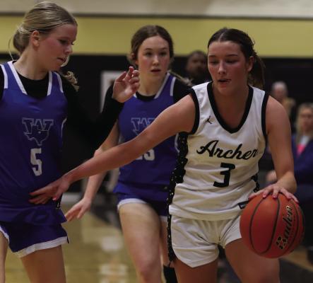 Archer City senior Serenity Jones dribbles down the court while being defender by Trojanette guard Jaylee Belcher on Friday. Photo/Landon Davis