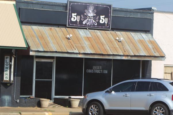Owner Gregg Miller has painted the windows at the property at 103 S. Center to block the view of the sunken roof. He is working with his insurance company to get the repairs done. Photo/Nathan Lawson