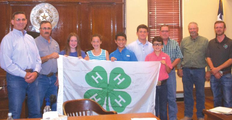 Left to right: County Judge Randy Jackson, Commissioner Pct. 4 Todd Herring, 4-H members Kensley Vieth, Gatlynn Revell, Ethan Anzaldua, Mason Gilmore, Jacob Anzaldua, Commissioner Pct. 3 Pat Martin, Commissioner Pct. 1 Wade Scarbrough and County Extension Agent Josh Smartt pose for a photo after the commissioners proclaim Oct. 3-9 as National 4-H Week. Photo/Nathan Lawson