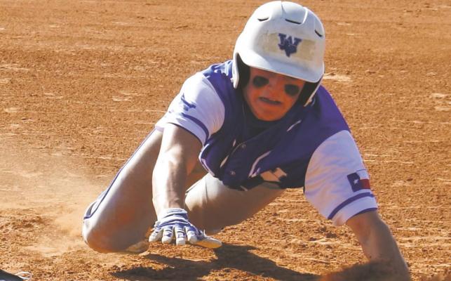 Windthorst’s Cooper Wolf scurries back to first base during the Trojans’ 13-0 win over Archer City on Friday, April 9. Photo/Will Edwards