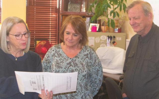 Archer County Elections Administrator Christie Mooney shows Republican Party Chair Leslie Hash (middle) and Democratic Party Chair Jerry Phillips some results from the March 1 primaries. Photo/Nathan Lawson