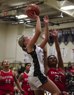 Archer City sophomore Ashlyn Harvey goes for a contested layup in the Lady Cats’ home-win over Electra on Friday, Jan. 30. Photo/Landon Davis