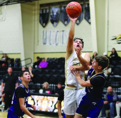 Archer City’s Maddox Mayo elevates over a Harrold Hornet defender in the Wildcats’ home win on Monday, Nov. 24. Photo/Landon Davis