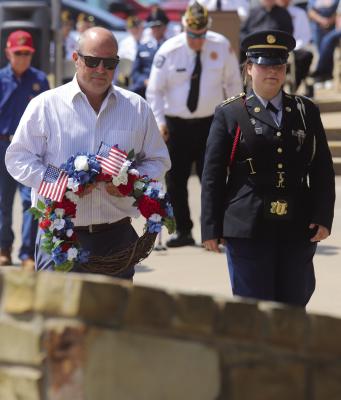 Aaron Blake, Nephew of Marine Corporal Leo Blake, prepares to lay a wreath at his uncle's memorial as part of the Windthorst Memorial Day ceremonies. Photo/Nathan Lawson