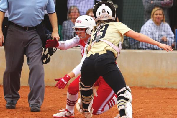 Archer City’s Vivian Rater makes the tag at the plate on Holliday’s Sydney Linn in the second inning as the Lady Eagles topped the Lady Cats 8-0 on Monday, Feb. 21. Photo/Will Edwards