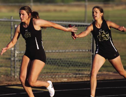 Archer City’s Millie Mayo (third leg) hands off the baton to Serenity Jones (fourth leg) in the 4x200 relay at the District 9-2A track and field meet in Petrolia on Thursday, April 9 Photo/Landon Davis