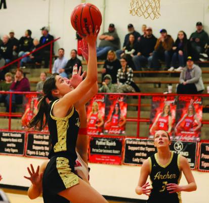 Archer City’s Malia Jones jumps through Lady Tiger contact for the layup. The senior Lady Cat finished with six points. Photo/Landon Davis