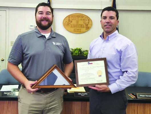 Ben Tucker was recognized by Archer City Mayor Jake Truette for his service to the city and was presented a Texas state flag flown over the Capitol in his honor. Tuckerserved on the Archer City City Council from 2015 to 2022. Courtesy photo/Kim Whitsitt