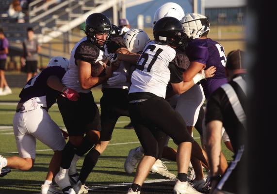 The Archer City Wildcats saw their first action of the season as they scrimmaged the Roscoe Plowboys at home on Friday, Aug. 14. Pictured is Wildcat Quarterback Seth Truette squeezing into the endzone for Archer City's first touchdown of the evening. Photo/Nathan Lawson