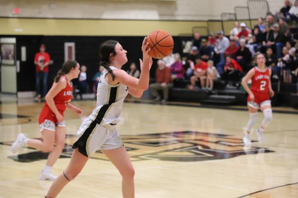 Archer City's MaKaylee McCown passes the ball to teammate