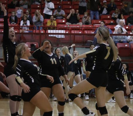 The Archer City Lady Cats celebrate a critical point in the win over Alvord on Thursday, Oct. 29, in Olney
