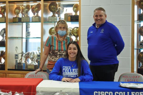 Holliday senior Bree Zellers, surrounded by friends and family, signed to play volleyball collegiately with Cisco College at the Holliday High School gym on Wednesday, Dec. 2.