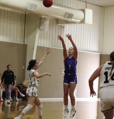 Junior Karissa Fillingim launches a three-pointer in the Trojanettes’ 56-32 victory over the Crowell Lady Cats in the First Annual Quanah Basketball Tournament on Saturday, Nov. 23. Courtesy photo/Jamie Anderle
