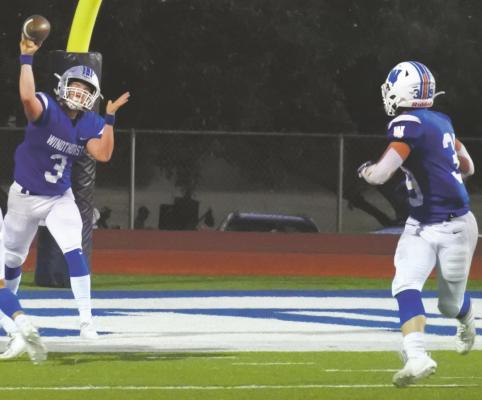 Senior quarterback Cy Belcher looks for senior Ethan Belcher over the middle in the first quarter of the Trojan’s 18-7 win over Muenster on Friday, Oct. 16. Photo/Will Edwards