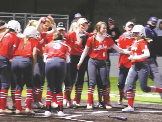 Holliday sophomore Sydney Linn trots home to celebrate with her teammates following her two-run dinger in the top of the second in the Lady Eagles’ 19-1 win over Archer City on Monday, Feb. 22, in Iowa Park. Photo/Will Edwards