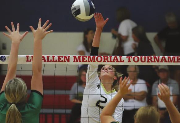 Archer City senior Mallory Maxwell hits over a pair of Breckenridge defenders in the first set of the Lady Cats’ 2-0 win over the Lady Bucks on Friday, Aug. 20, at the Lu Allen Memorial Tournament. Photo /Will Edwards