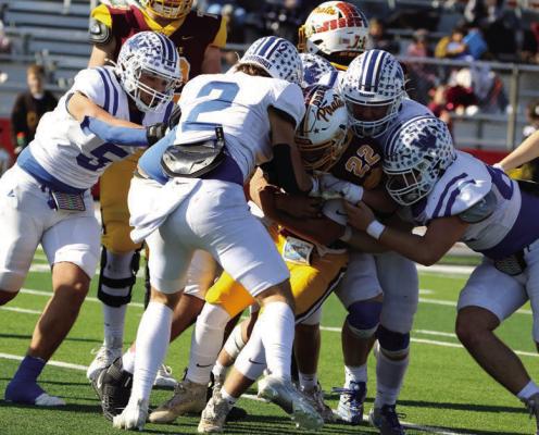 A host of Trojan defenders make the tackle on a Collinsville ball-carrier in Windthorst’s Regional Semifinals playoff round. Photo/Landon Davis