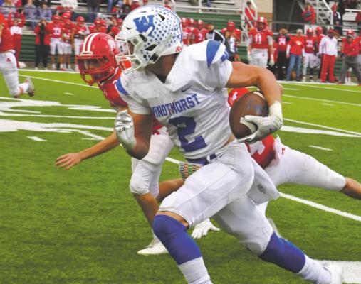 Kyle Wolf breaks free down the sidelines for a 67-yard gain to set up the go-ahead score by the Trojans late in the fourth quarter of Windthorst’s 18-13 win over Albany in the regional semifinals on Friday, Nov. 27. Photo/Will Edwards