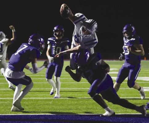Sophomore quarterback Brock Belcher leaps for the endzone in the Trojan’s 21-20 overtime win over City View on Friday, Sept. 6 Photo/Landon Davis