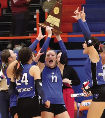 Rylee Wolf (11), Abby Schroeder (24), Saige Anderson (right) and Annikah Frank celebrate with the Class 2A-Region I Trophy following a sweep of Tolar Saturday, Nov. 11. Photo/Nathan Lawson