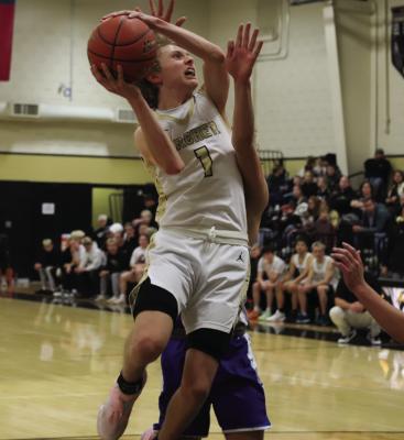 Wildcat senior Kellar Crow fights through a Trojan defender for the bucket in Archer City’s home matchup versus Windthorst on Tuesday. Photo/Landon Davis