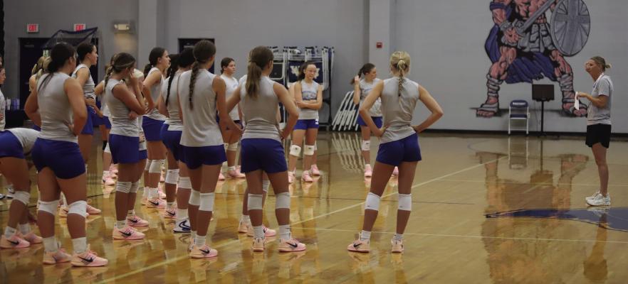Windthorst head coach Allison Bussey speaks to her team during practice as the Trojanettes prepare for the 2026-27 volleyball season. Bussey enters her 12th season at Windthorst looking to lead the team back to the state tournament. Photo/Rolando Medina