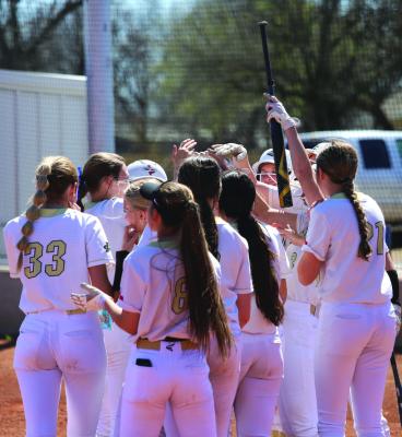 The Archer City Lady Cats gather at home plate to celebrate Addy Peter's home run bomb. Photo/Landon Davis