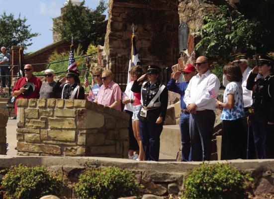 Family members, VFW Post 2676 members and members of the Legacy High School JROTC remember fallen armed forces members Gary S. Johnston, Paul Himmels and Leo Blake during the playing of TAPS at the Memorial Day ceremonies at the grotto of St. Mary's Catholic Church on Monday, May 25. Photo/Nathan Lawson