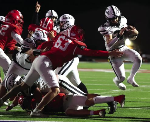 Wildcat running back Isaac Dieguez leaps for the goal line in Archer City’s Area playoff round matchup versus the Albany Lions on Thursday, Nov. 21 in Graham Photo/Landon Davis